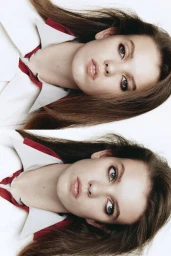 Portrait of a female model wearing a white collared shirt with red trim against a seamless white background.