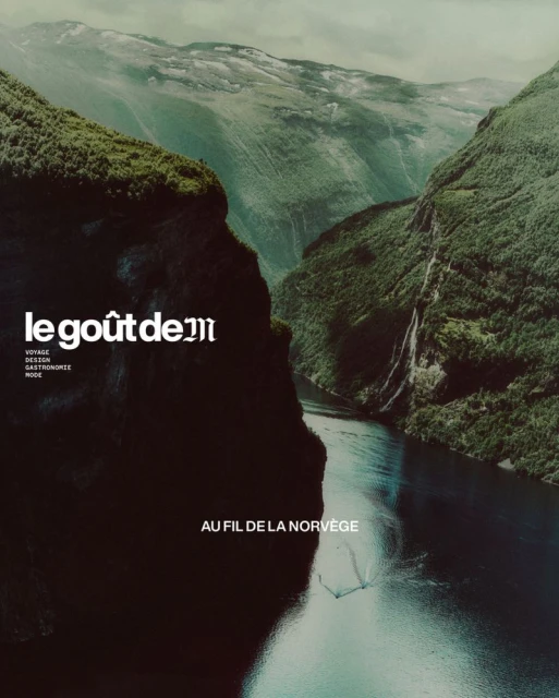 Aerial view of a steep mountain valley with dark water running through a Norwegian fjord, featuring overlaid magazine text.