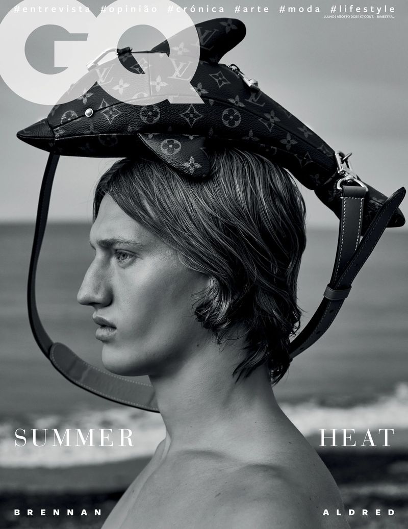 GQ magazine cover featuring a young man with a dolphin-shaped Louis Vuitton bag on his head, photographed outdoors by the ocean.