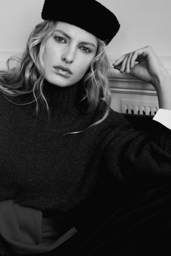 Model Felice Nova Noordhoff wearing a dark turtleneck and black pillbox hat for COS Pre-Winter 2026