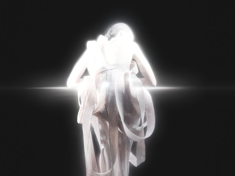 Back view of a light-skinned adult woman wearing a shimmering white gown with ribbons against a dark studio backdrop with a horizontal light flare.