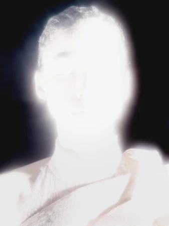 High-key portrait of an adult with a bright overexposed lighting creating a glowing effect, shot with a shallow depth of field.