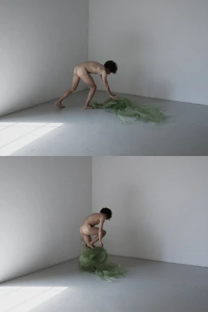 Striking studio art photograph featuring a nude adult and airy green fabric, creating a surreal, minimalist aesthetic in a white corner.