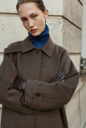 Model Vika Evseeva wearing a brown coat and blue turtleneck for Massimo Dutti