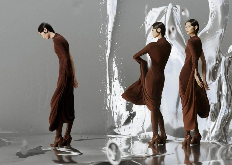 Model in a brown dress standing against a liquid silver backdrop for Harper's Bazaar Australia