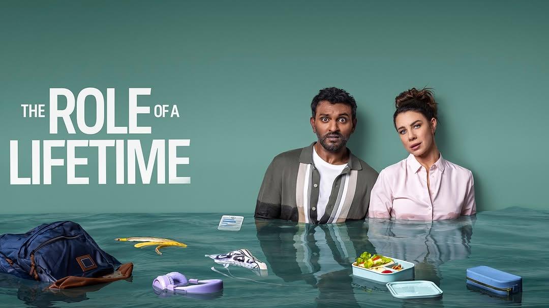 Two people stand waist-deep in water alongside a backpack, headphones, and lunchbox with the words 'The Role of a Lifetime' above.