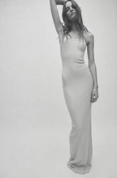 Model Tilda Lindstam wearing a long ribbed tank dress against a plain white seamless studio background.
