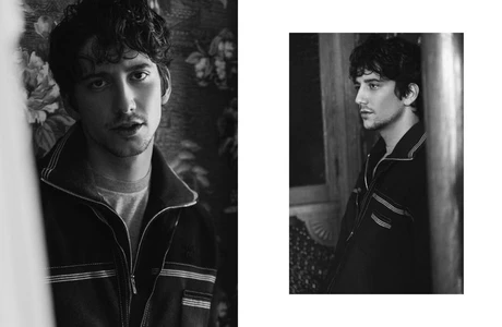 Monochrome portrait diptych of Milo Manheim wearing a dark collared jacket with contrast piping against a patterned wall