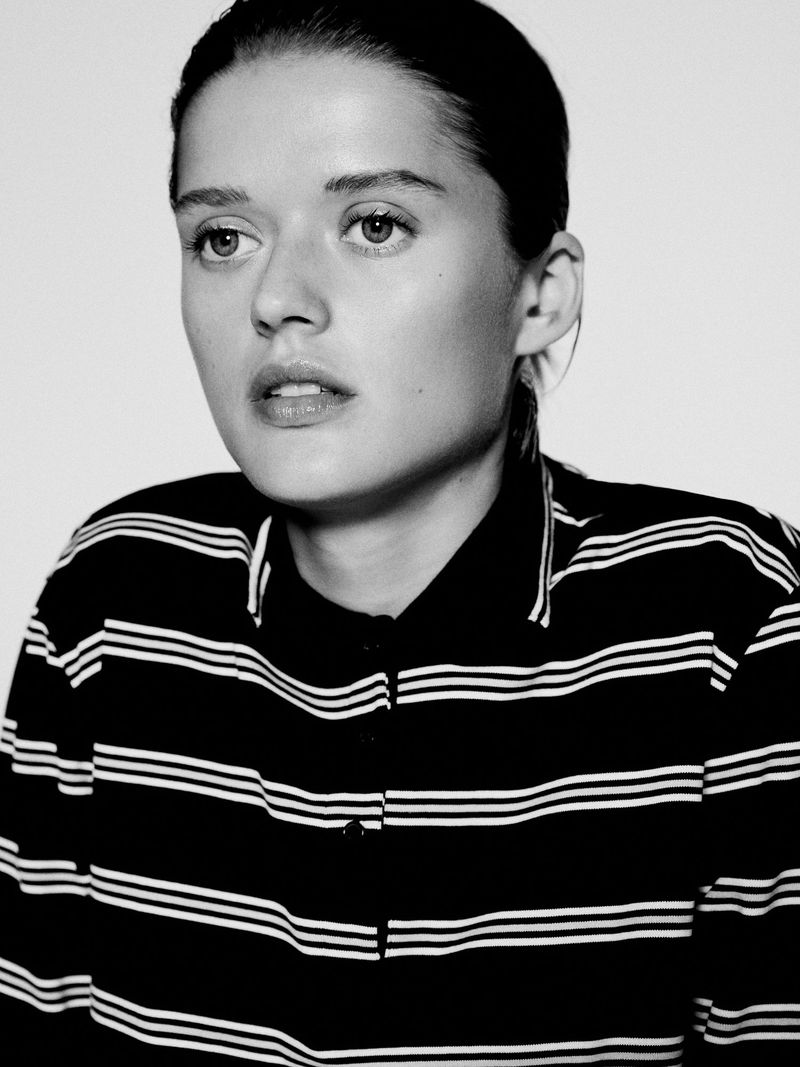 Portrait of a woman wearing a striped polo shirt against a plain white background for Massimo Dutti S/S 25