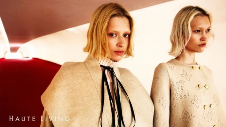 Two female models posing in designer clothing for the Louis Vuitton Pre-Fall 2025 collection editorial in Haute Living Magazine.