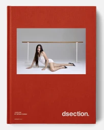 Judeline reclining on a white floor in front of a ballet barre for DSECTION Magazine editorial photography by Bryan Torres.