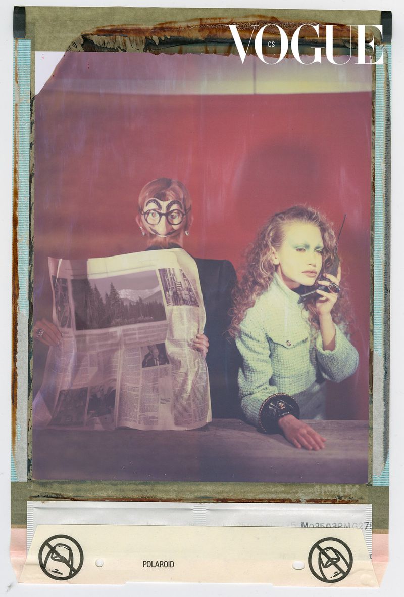 Magazine cover featuring a woman talking on a vintage telephone and a man holding a newspaper, set against a dark red background.
