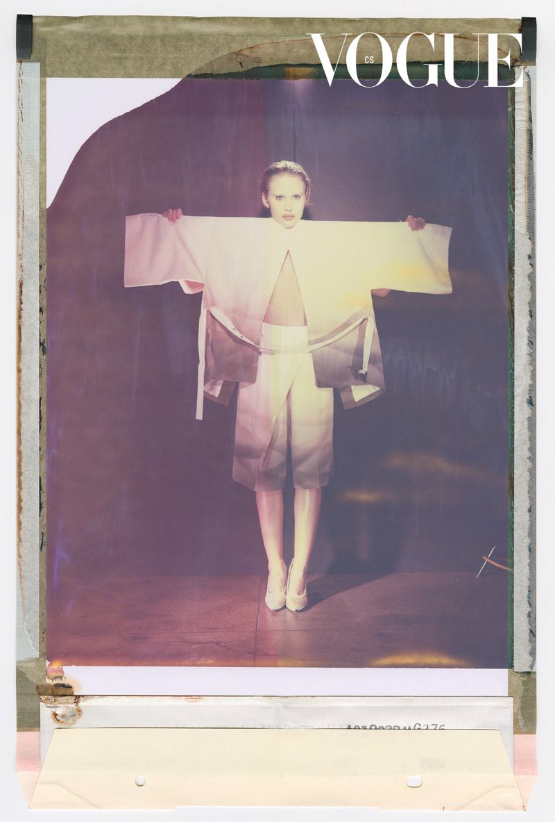 Vintage Vogue magazine cover featuring a person in a white and grey kimono-style outfit against a dark, blurred background.