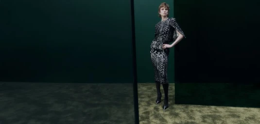 Model standing in patterned black and white dress against a dark green studio backdrop for Harrods New Season 2026 campaign.