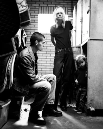 Monochrome fashion editorial image showing three models in a locker room setting for Numero Netherlands project Serenity.