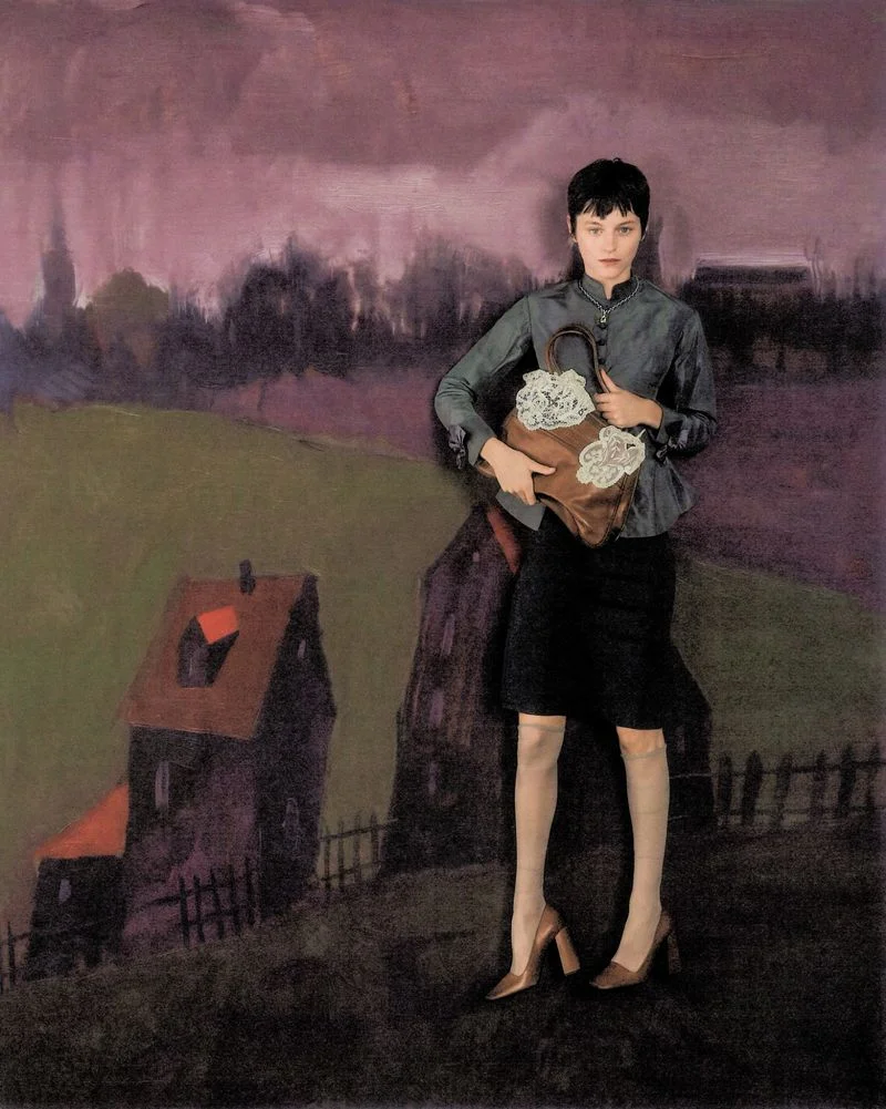 Emma Corrin holding a brown handbag standing against a painted landscape backdrop for Harper's Bazaar UK