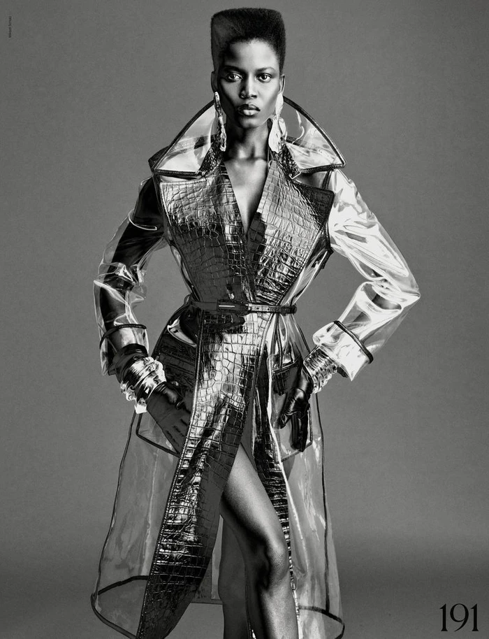Model Ajah Angau Jok in transparent coat with structured high top haircut in black and white fashion editorial for French Magazine