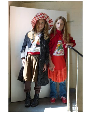 Two children modeling youth fashion wear featuring a red polka dot hat and colorful garments for i-D Magazine