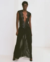 Janet Jumbo in a sheer black gown with embroidered panels against a white seamless studio backdrop for EWUSIE S/S 27