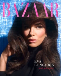 Eva Longoria with dark hair wearing a black top against a sparkly blue background for Harper's Bazaar Turkey.