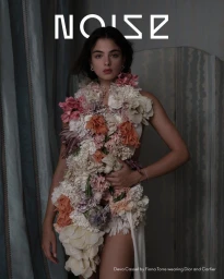 Deva Cassel wearing a floral garment in a moody indoor setting for Beyond Noise Issue 6 Covers