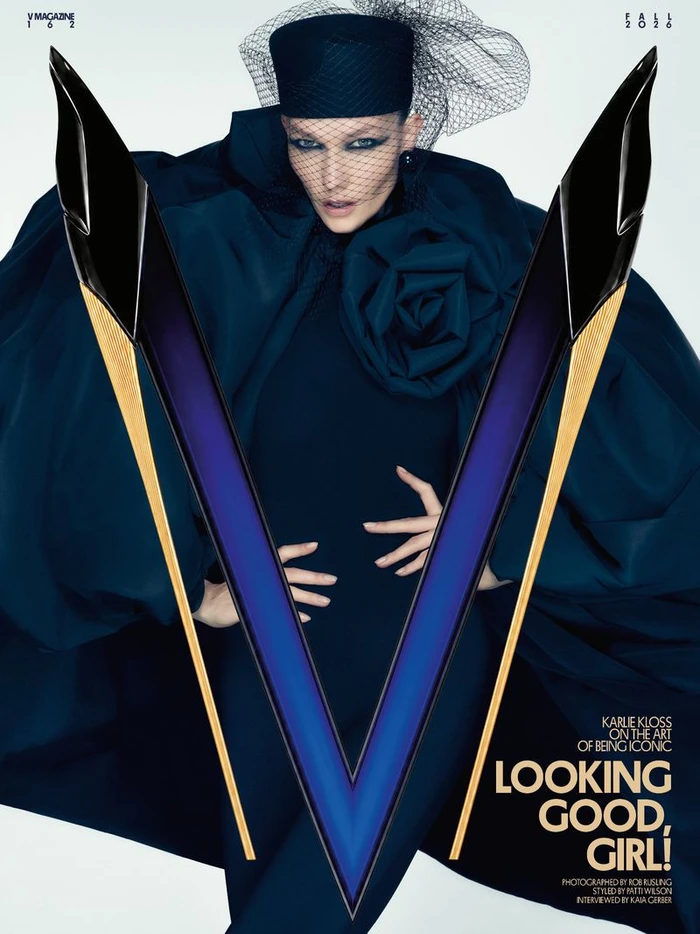 Karlie Kloss wearing a dark sculptural coat and pillbox hat with veil for V Magazine Fall 2026 cover