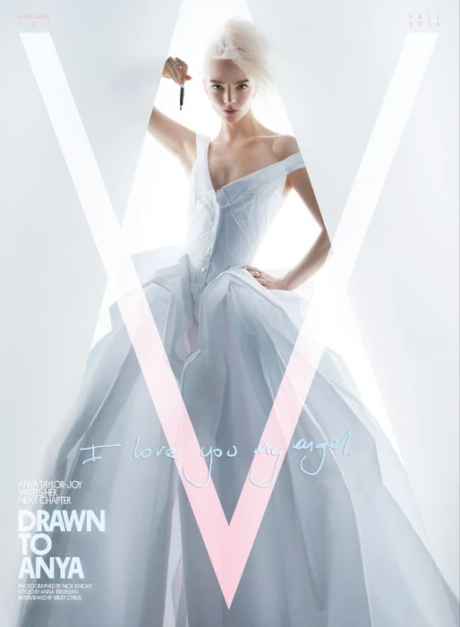 Anya Taylor-Joy in a white gown holding a pen against a bright white background for V Magazine