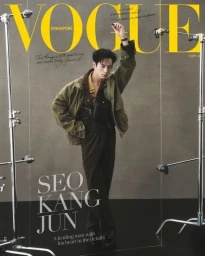 Man wearing olive jacket and brown trousers posing on set for Vogue Singapore