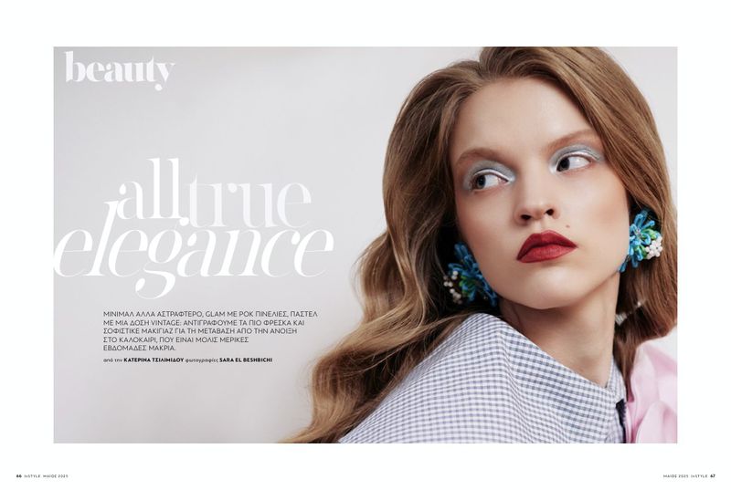 Beauty editorial featuring a woman with silver eyeshadow, red lipstick, and statement floral earrings, posing against a clean white background.
