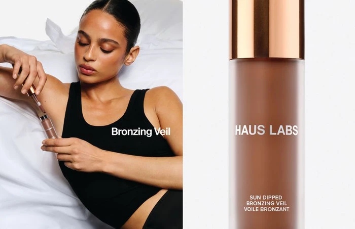 Model wearing a black tank top holding a bronzing product next to a Haus Labs Sun Dipped Bronzing Veil bottle