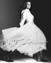 Julia Fox wearing a white midi dress with a voluminous tulle skirt for the Betsey Johnson Holiday 2026 Campaign