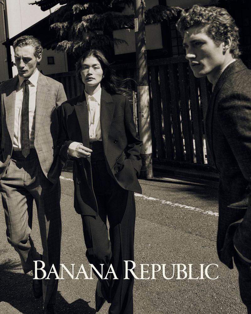 Three models in tailored suits walking down an outdoor street for Banana Republic campaign photographed by Sonia Szostak