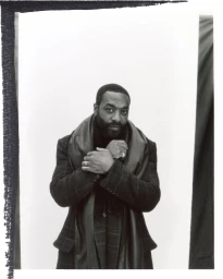 Chiwetel Ejiofor wearing a plaid coat and dark scarf in a portrait for Esquire UK photographed by Nick Thompson.