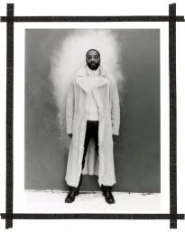 Chiwetel Ejiofor in a long white shearling coat against a textured studio backdrop for Esquire UK The Shapeshifter project.