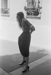 Woman in dark skirt and patterned top standing outside on a sunny street for the Another Way project by Crosscurrent.