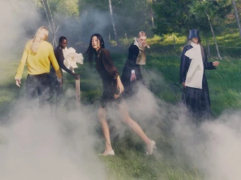 Five diverse models walking through a misty grassy meadow for a Vogue Scandinavia fashion editorial by Julius Bohlin.
