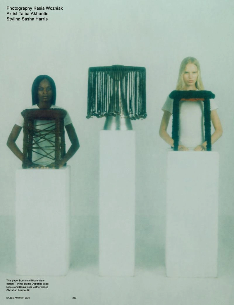 Two models standing behind white plinths holding sculptural objects alongside a tall central pillar in Dazed Magazine Braid New World editorial