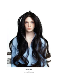 Model Lilja Drab with elaborate braided black hair wearing a blue shirt against a white seamless background for 10 Magazine Deutsch