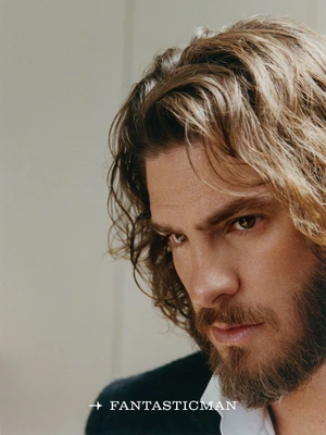 Portrait of Andrew Garfield with medium-length wavy brown hair and a beard for Fantastic Man China by Micaiah Carter.