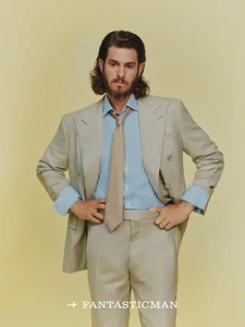 Andrew Garfield wearing a beige suit and blue striped shirt with a tie against a plain yellow background for Fantastic Man China.
