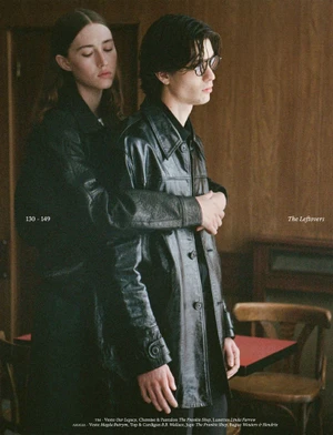 Two models in dark leather jackets embracing indoors against wood paneling for Cœur Magazine