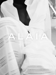 Model wearing a white shirt and textured white pants in a black and white fashion portrait for Alaïa ARCHETYPES SF 26.