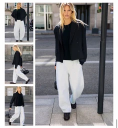 Model in a black jacket and white trousers walking on an urban street for Pull and Bear A/W 2026