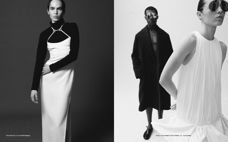 A black and white editorial fashion shot of models wearing dresses and coats, set against contrasting dark and bright backgrounds.