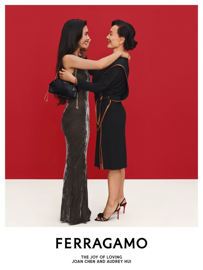Joan Chen and Audrey Hui embracing in a campaign image for Ferragamo Holiday 2026, photographed by Ilya Lipkin.