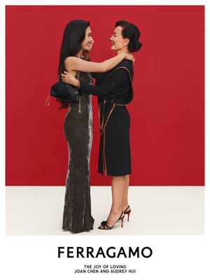 Joan Chen and Audrey Hui embracing in a campaign image for Ferragamo Holiday 2026, photographed by Ilya Lipkin.