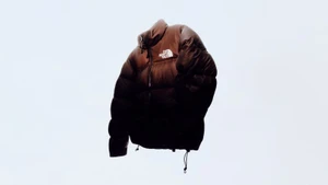 Glossy brown puffer jacket featuring the white brand logo on the chest against a bright white background