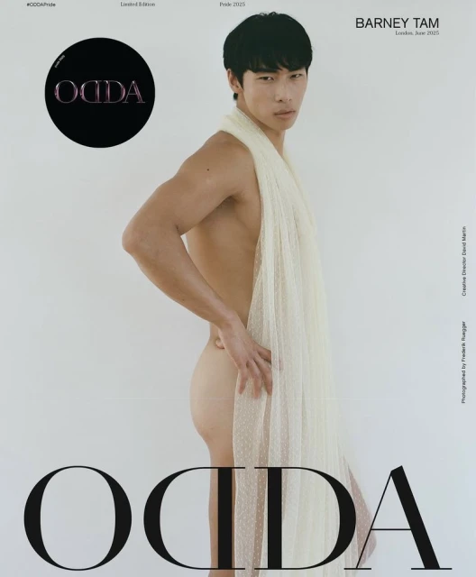 Fashion editorial featuring a shirtless Asian man wrapped in a sheer, textured fabric on a clean white backdrop, studio lighting.