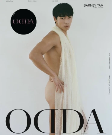 Fashion editorial featuring a shirtless Asian man wrapped in a sheer, textured fabric on a clean white backdrop, studio lighting.