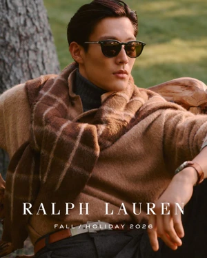 Model wearing dark sunglasses, camel sweater and plaid scarf in outdoor setting for Ralph Lauren Fall Holiday 2026